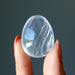 hand holding clear quartz crystal egg.