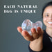 hand holding clear quartz crystal eggs 