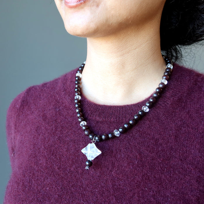 wearing clear quartz merkaba pendant on beaded faceted brown chalcedony necklace