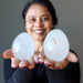 sheila of satin crystals holding two Cloud Quartz Eggs one on each palm