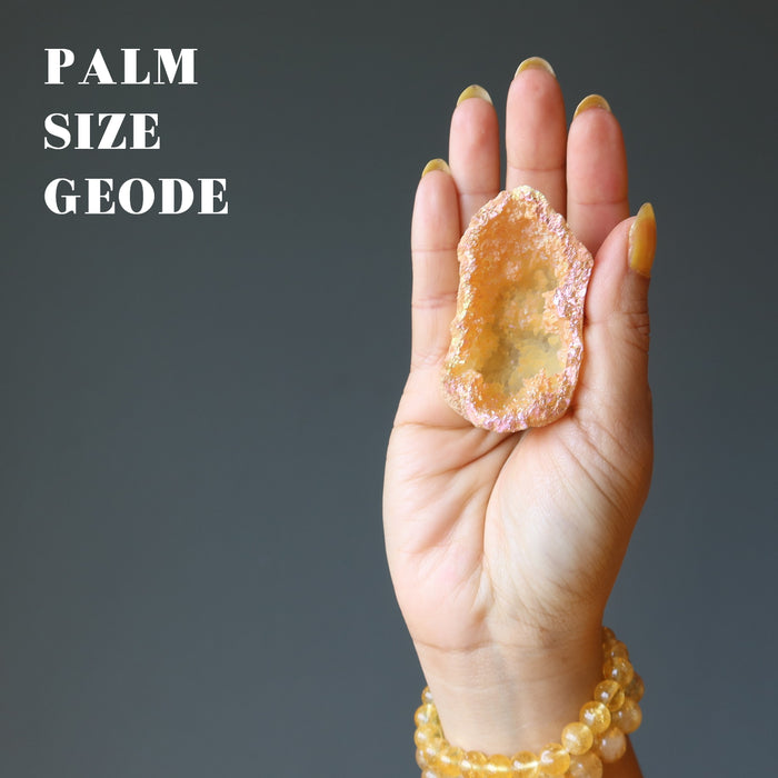 rainbow aura quartz geode in palm