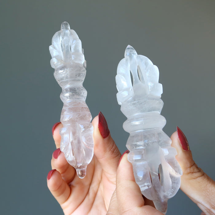 hands holding clear quartz dorje wands showing each is unique