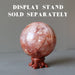 red quartz sphere on fancy wood display stand, which is sold separately