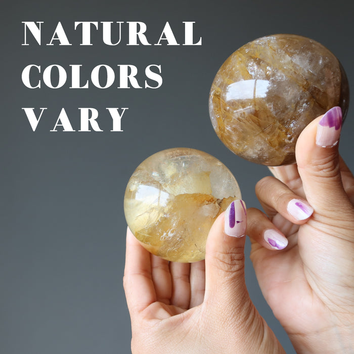 two golden quartz spheres showing natural colors vary