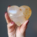 hand holding Golden Milky Hematoid Quartz Heart