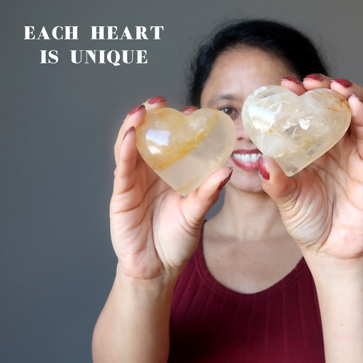 sheila of satin crystals holding two golden hematoid quartz hearts