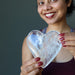 sheila of satin crystals holding a big Clear Quartz Heart
