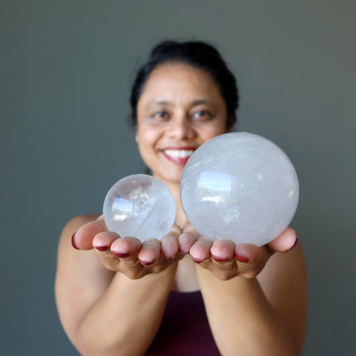 sheila of satin crystals holding two included quartz spheres