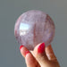 hand holding lavender quartz sphere