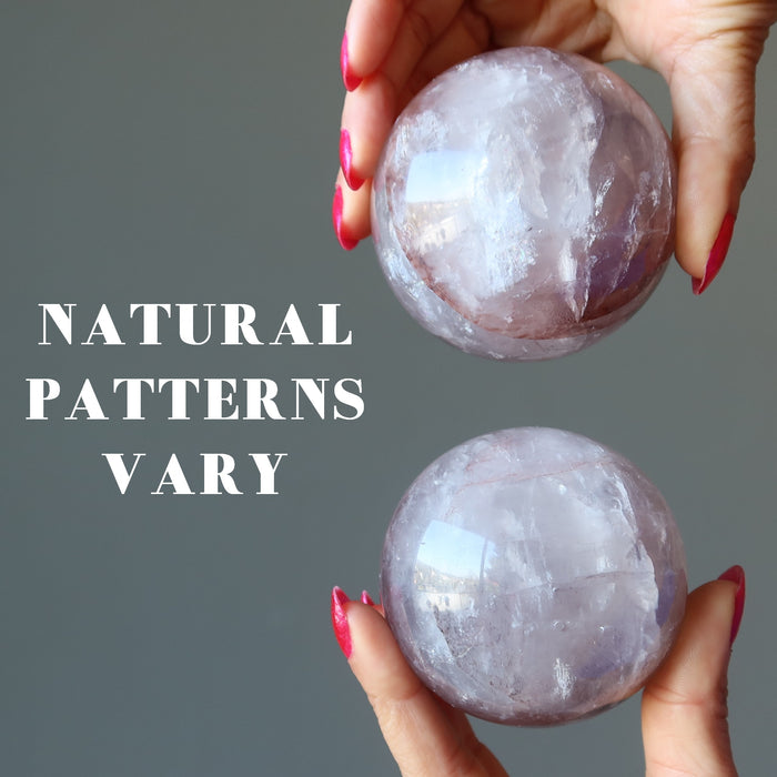 hands holding lavender quartz spheres showing natural patterns vary