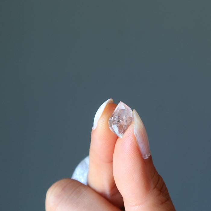 holding a Terminated Raw Clear Quartz gemstones in zero gravity case