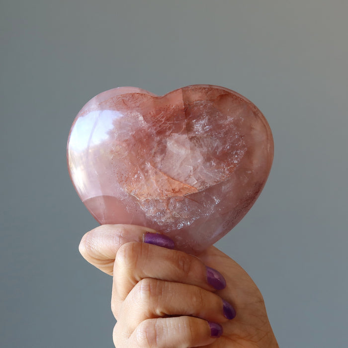 hand holding red fire quartz heart