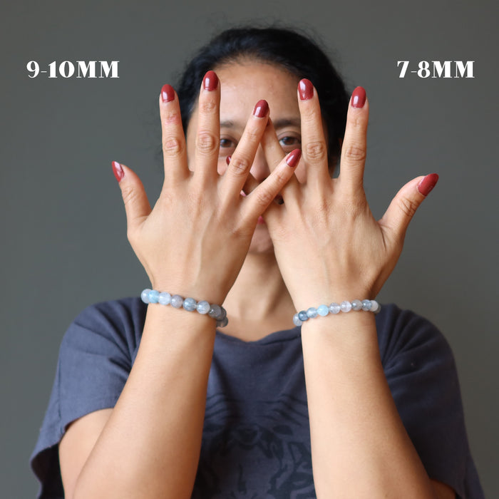 woman modeling two blue rutilated quartz bracelets to show size difference