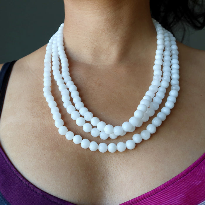 sheila satin of satin crystals wearing Snow white Quartz round beads strung in 3-strands of necklace on an adjustable tasseled clasp