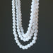 showing  Snow white Quartz round beads strung in 3-strands of necklace 
