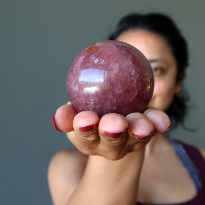 sheila of satin crystals holding a strawberry quartz crystal ball