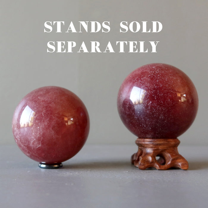 two pink quartz spheres on stands