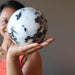 sheila of satin crystals holding a large tourmalinated quartz sphere