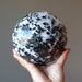 hand holding big tourmalined quartz sphere