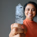 woman holding tourmalinated quartz tower