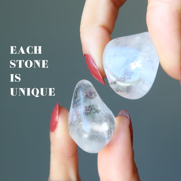 hands holding chlorite quartz tumbled stones