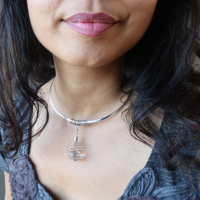 female wearing quartz cage necklace
