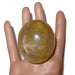 Golden Quartz stone on mannequin hand
