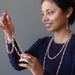 sheila of satin crystals admiring and wearing rhodochrosite necklaces