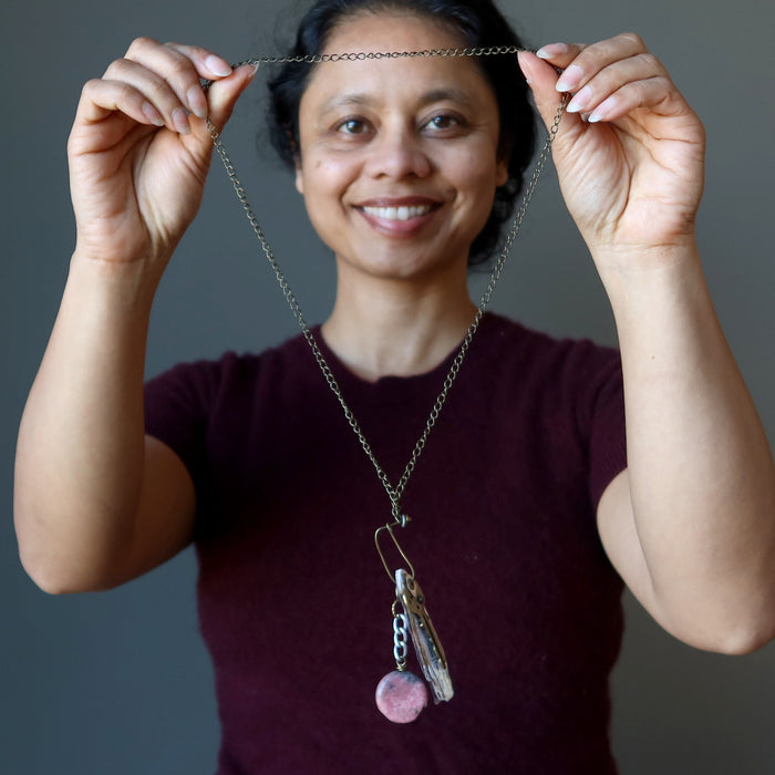 woman wearing rhodonite key necklace