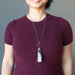 woman wearing rhodonite key necklace