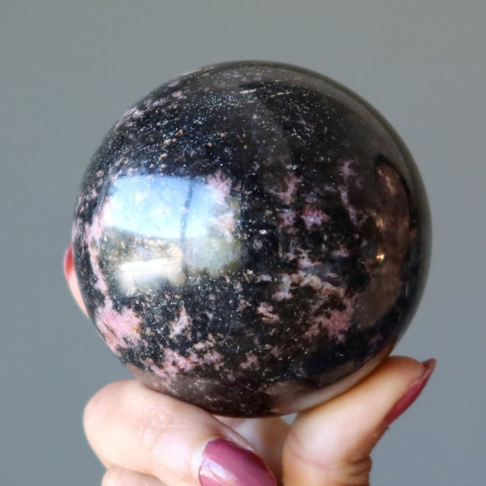 pink and black rhodonite sphere