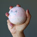 peruvian rhodonite sphere in hand