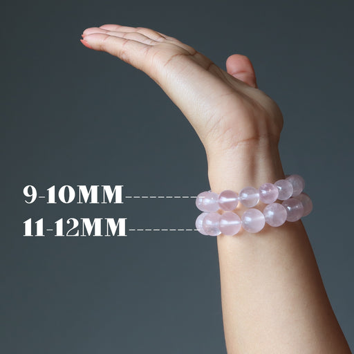 hand wearing two rose quartz bracelet showing size difference in beads