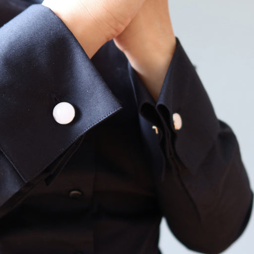 black french cuffs secured with rose quartz cufflinks