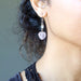 sheila of satin crystals wearing rose quartz heart earrings with sparkling crystal accents 