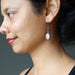 rose quartz earring on ear