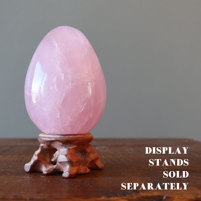 dark pink star rose quartz egg on wood display stand which is sold separate