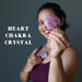 woman holding rose quartz hearts at the heart chakra