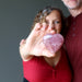 woman holding out a rose quartz heart