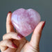 hand holding rose quartz heart