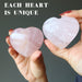 hands holding pink rose quartz crystal hearts to show each is unique