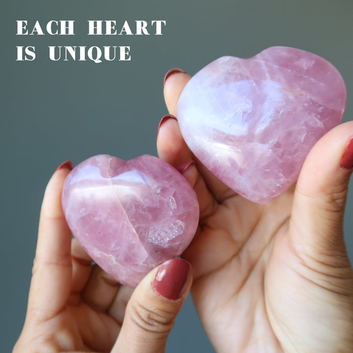 hand holding rose quartz hearts