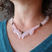 rose quartz flame necklace on female neck