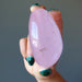 hand holding pink rose quartz polished palm stone