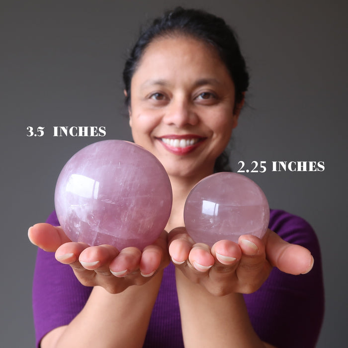 rose quartz spheres in hands