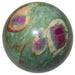 green and white fuchsite sphere with red ruby inclusions