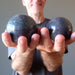 male model holding two ruby kyanite spheres