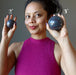 female model holding two ruby kyanite spheres