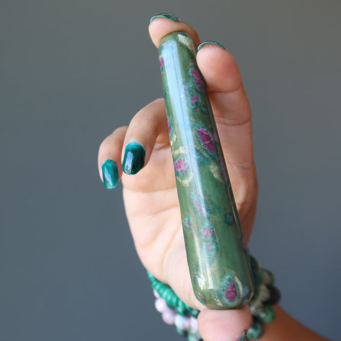 hand holding ruby zoisite tapered massage wand