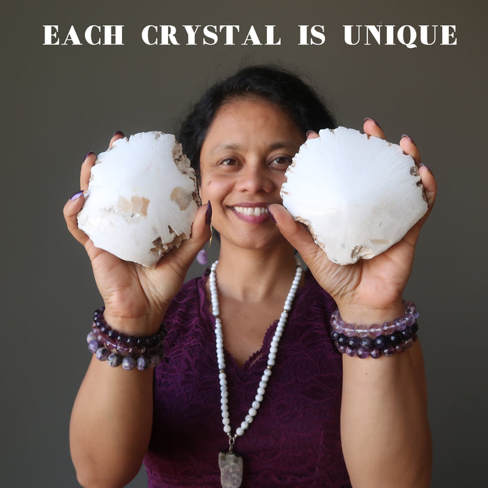 sheila of satin crystals holding raw white scolecite domes